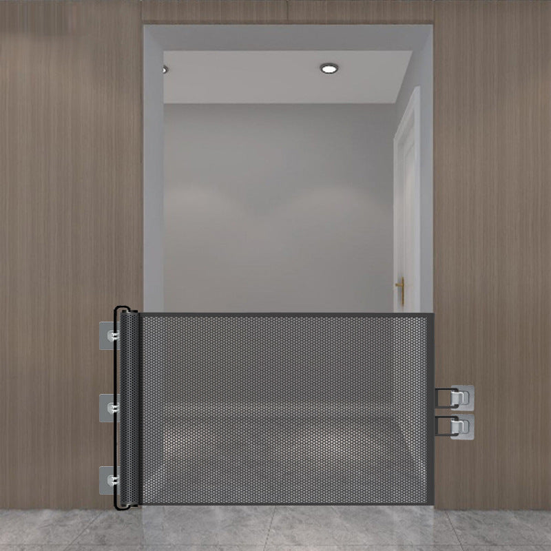 Black retractable mesh pet gate spanning a wide hallway