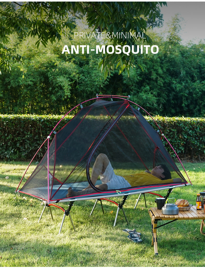 Khaki off-ground camping tent canopy with mosquito net over a camp cot