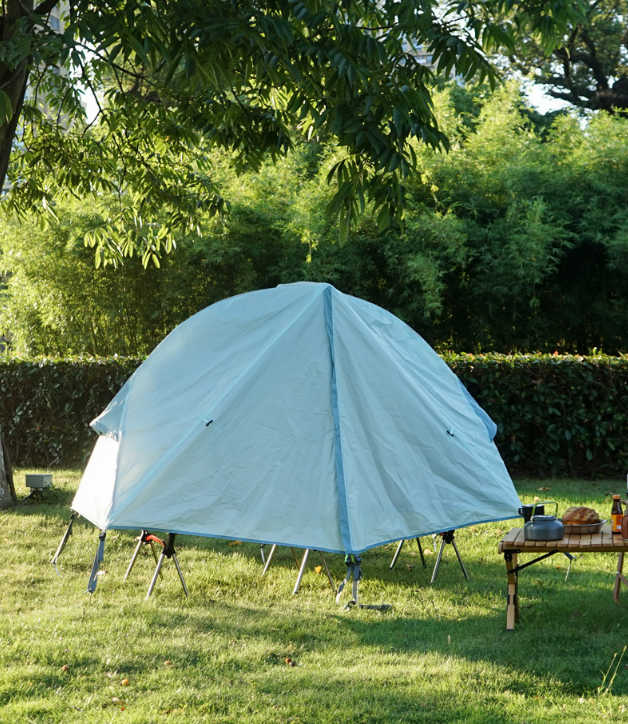 Khaki off-ground camping tent canopy with mosquito net over a camp cot
