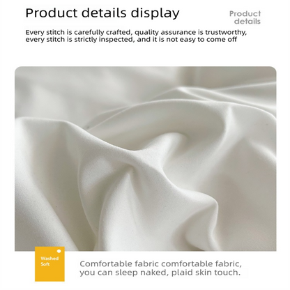 Light grey washed cotton bedding set made up on a bed