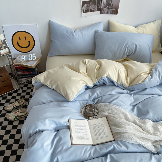Light blue washed cotton bedding set made up on a bed