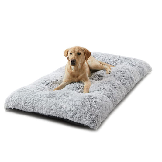 Thick grey plush winter dog bed with long faux fur on a timber floor