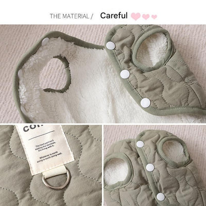 Beige quilted dog vest with leash ring beside a coffee-coloured oval fleece pet bed