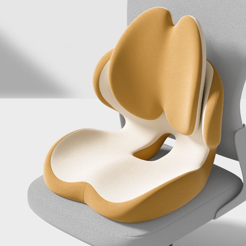 Yellow memory foam seat cushion with integrated lumbar support on a chair