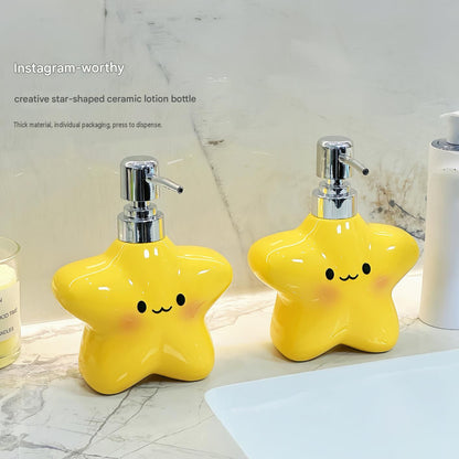 Yellow star bathroom set with plastic toothbrush holder and two ceramic pump bottles