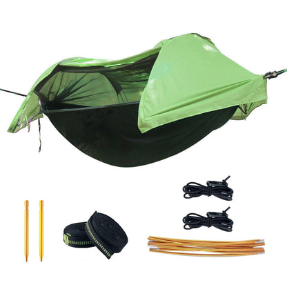 Double camping hammock tent with mosquito net strung between two trees