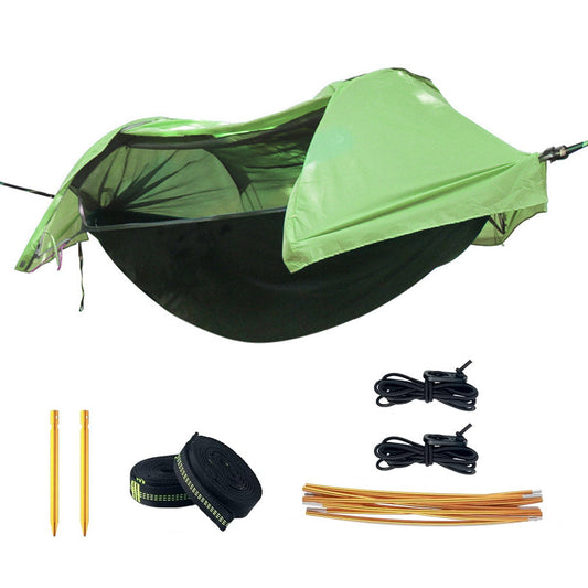 Double camping hammock tent with mosquito net strung between two trees