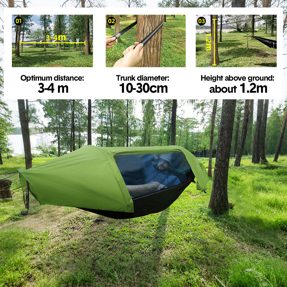 Double camping hammock tent with mosquito net strung between two trees
