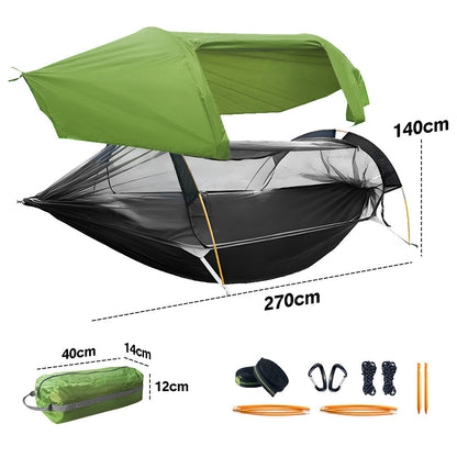Double camping hammock tent with mosquito net strung between two trees