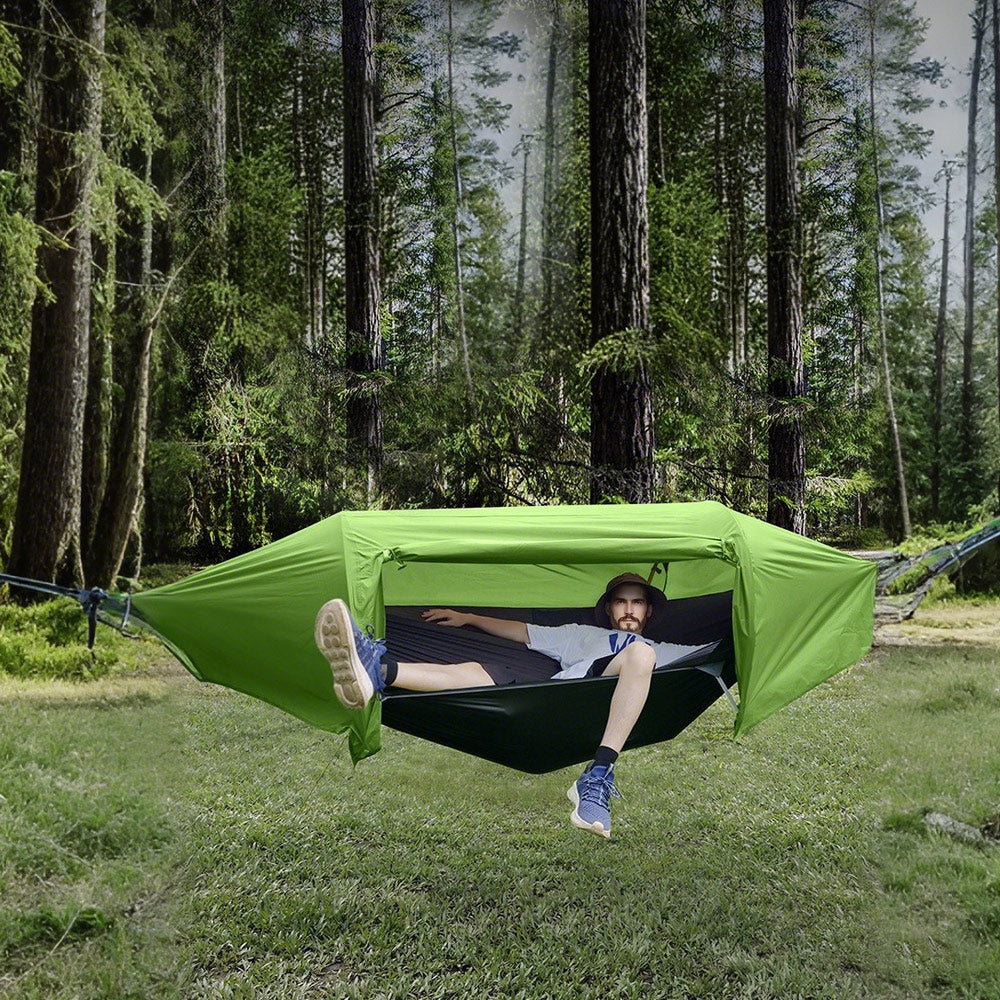 Double camping hammock tent with mosquito net strung between two trees