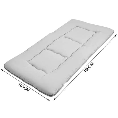 Grey foldable futon mattress with a smooth polyester cover for floor sleeping